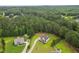 Aerial view of a home with lush green lawns and mature trees, surrounded by woods at 3 Tiffany Trce, Palmetto, GA 30268