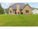 Large, grassy backyard with a view of the home's exterior, including a patio and grill at 3 Tiffany Trce, Palmetto, GA 30268