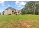 Expansive backyard with lush green grass and mature trees, offering ample space for recreation at 3 Tiffany Trce, Palmetto, GA 30268
