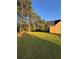 A verdant backyard setting, featuring towering trees and expansive lawn space next to the home at 3 Tiffany Trce, Palmetto, GA 30268