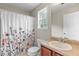 Bathroom with sink, toilet, shower/tub combination and flowered shower curtain at 3 Tiffany Trce, Palmetto, GA 30268