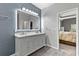 Well-lit bathroom with double sink vanity, decorative mirror, and neutral color palette with easy access to bedroom at 3 Tiffany Trce, Palmetto, GA 30268