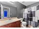 Bathroom featuring a neutral-toned vanity with a sink, toilet, and a patterned shower curtain at 3 Tiffany Trce, Palmetto, GA 30268