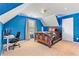 Bright blue bedroom featuring a wooden bed frame, desk, and modern lighting for a youthful space at 3 Tiffany Trce, Palmetto, GA 30268