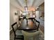 Open-concept dining room featuring a long wooden table with chairs and modern light fixture at 3 Tiffany Trce, Palmetto, GA 30268