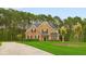 Attractive two-story home boasting manicured lawn and mature trees, blending brick and wood siding for a welcoming curb appeal at 3 Tiffany Trce, Palmetto, GA 30268