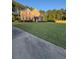 Well-maintained home with a large, green lawn and mature landscaping at 3 Tiffany Trce, Palmetto, GA 30268