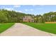Inviting two-story home with a long driveway, expansive lawn, and mature trees, offering a blend of comfort and classic style at 3 Tiffany Trce, Palmetto, GA 30268