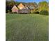 Charming two-story home with a spacious front yard and mature trees at 3 Tiffany Trce, Palmetto, GA 30268