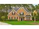 Charming two-story home featuring brick and wood siding, a manicured lawn, and mature trees, offering classic curb appeal at 3 Tiffany Trce, Palmetto, GA 30268