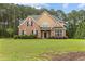 Charming two-story brick home with a well-manicured lawn and mature trees at 3 Tiffany Trce, Palmetto, GA 30268
