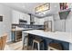 Kitchen with bar seating features stainless appliances, wine fridge, and modern white countertops with navy cabinets at 3 Tiffany Trce, Palmetto, GA 30268
