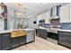 Modern kitchen includes gold accents, stainless appliances, wine fridge, quartz counters, and island seating at 3 Tiffany Trce, Palmetto, GA 30268