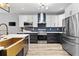 Updated kitchen features a stainless fridge, modern appliances, white and navy cabinets and gold hardware at 3 Tiffany Trce, Palmetto, GA 30268