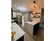 Kitchen features a large island with seating, pendant lighting, stainless appliances, and two-tone cabinets at 3 Tiffany Trce, Palmetto, GA 30268