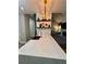 Kitchen island featuring a waterfall countertop, floating shelves, and open concept living space at 3 Tiffany Trce, Palmetto, GA 30268