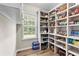 Walk-in pantry features wood floors, a window and extensive custom shelving at 3 Tiffany Trce, Palmetto, GA 30268
