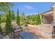Outdoor living on the back deck with a grill, outdoor dining, fire pit, and beautiful landscaping at 3179 Falls Crest Ct, Buford, GA 30519