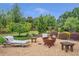 Landscaped backyard with a fire pit and outdoor seating area at 3179 Falls Crest Ct, Buford, GA 30519