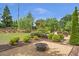 Beautiful backyard with a fire pit and lush landscaping makes this home feel like a private oasis at 3179 Falls Crest Ct, Buford, GA 30519