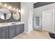Hall bathroom with double sinks, stylish mirrors and fixtures, shiplap wall, and plenty of storage at 3179 Falls Crest Ct, Buford, GA 30519