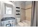 Contemporary bathroom with floating shelves, tiled shower, and modern sink at 3179 Falls Crest Ct, Buford, GA 30519