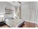 Cozy bedroom with hardwood floors, floating shelves, ceiling fan, and warm lighting at 3179 Falls Crest Ct, Buford, GA 30519