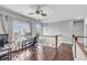 Spacious bonus room with hardwood floors, high ceilings, a ceiling fan, and two workstations at 3179 Falls Crest Ct, Buford, GA 30519