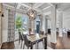 Bright dining area with an oversized light fixture and many windows at 3179 Falls Crest Ct, Buford, GA 30519