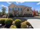 Charming two-story brick home with a well-manicured front yard and an attached two-car garage at 3179 Falls Crest Ct, Buford, GA 30519