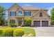 Stunning two-story brick home with a manicured lawn and attached two-car garage at 3179 Falls Crest Ct, Buford, GA 30519