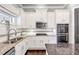 Bright kitchen with white cabinets, granite countertops, and stainless steel appliances at 3179 Falls Crest Ct, Buford, GA 30519