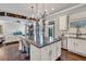 Stylish kitchen island with seating, view into the living room, and backyard access at 3179 Falls Crest Ct, Buford, GA 30519