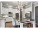 Spacious kitchen featuring a large island, modern lighting, and stainless steel appliances at 3179 Falls Crest Ct, Buford, GA 30519
