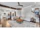 Open-concept living room with hardwood floors flowing into the modern kitchen at 3179 Falls Crest Ct, Buford, GA 30519