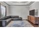 Comfortable living room with a large TV, hardwood floors, tray ceilings, and comfortable seating at 3179 Falls Crest Ct, Buford, GA 30519