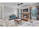 Cozy living room with stone fireplace, plush seating, and a decorative accent cabinet at 3179 Falls Crest Ct, Buford, GA 30519
