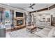 Bright living room with stone fireplace, hardwood floors, and a view into the modern kitchen at 3179 Falls Crest Ct, Buford, GA 30519