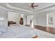Spacious main bedroom featuring tray ceilings, hardwood floors, and connected spaces at 3179 Falls Crest Ct, Buford, GA 30519