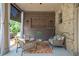 Cozy covered patio featuring brick accents, comfortable seating, and shaded privacy at 3179 Falls Crest Ct, Buford, GA 30519