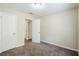 Bedroom with two white doors, brown carpet, and neutral colored walls at 3242 College St, Atlanta, GA 30337