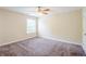 Neutral bedroom with plush carpet, ceiling fan, and natural light at 3242 College St, Atlanta, GA 30337