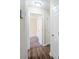 Hallway leading to carpeted bedroom with neutral paint and new flooring at 3242 College St, Atlanta, GA 30337