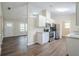 Modern kitchen featuring white cabinets, stainless steel appliances, and hardwood floors at 3242 College St, Atlanta, GA 30337
