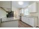 Modern kitchen with white cabinets, stainless steel appliances, and granite countertops at 3242 College St, Atlanta, GA 30337