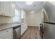 Modern kitchen featuring white cabinets, stainless steel appliances, and granite countertops at 3242 College St, Atlanta, GA 30337
