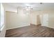 Bright living room featuring hardwood floors, a ceiling fan, and large windows at 3242 College St, Atlanta, GA 30337