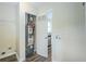 Utility room featuring a water heater, washer hookups, and new laminate flooring at 3242 College St, Atlanta, GA 30337