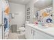bathroom features colorful shower curtain, white vanity, and great lighting at 450 Rockfern Ct, Lilburn, GA 30047
