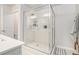 Modern bathroom with a tiled shower, a glass door, and white tile at 450 Rockfern Ct, Lilburn, GA 30047
